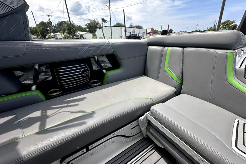 Slide: The Image of 2016 Nautique Super Air Nautique G25 Coastal Edition interior with gray and green seating. - 52