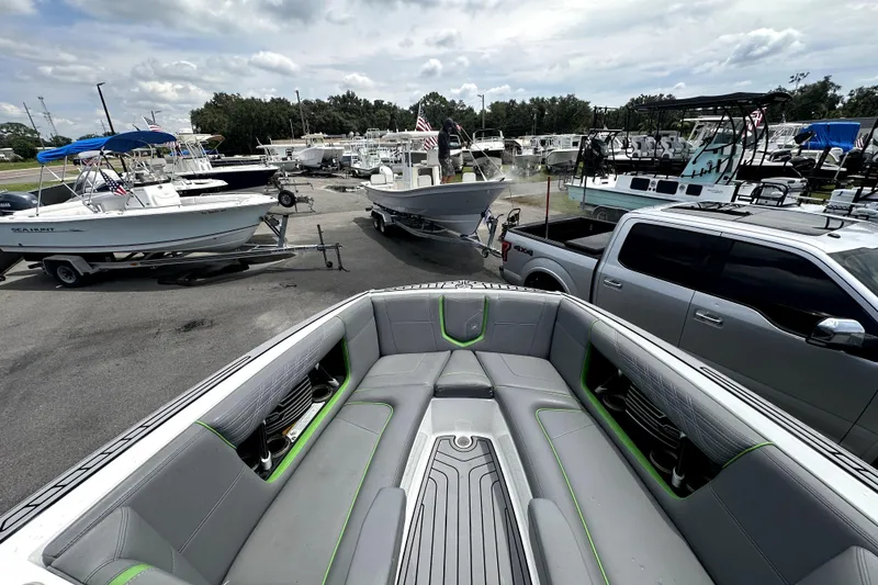 Slide: The Image of 2016 Nautique Super Air Nautique G25 Coastal Edition boat interior with gray and green seating. - 53