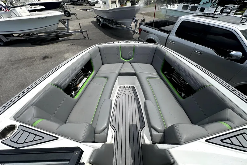 Slide: The Image of 2016 Nautique Super Air Nautique G25 Coastal Edition boat interior with gray and green seating. - 54