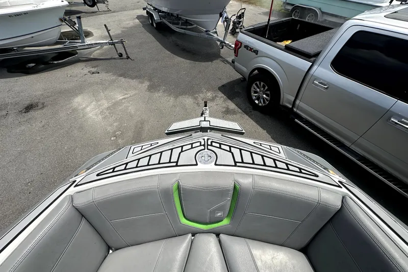 Slide: The Image of 2016 Nautique Super Air Nautique G25 Coastal Edition interior seating with green accents. - 55