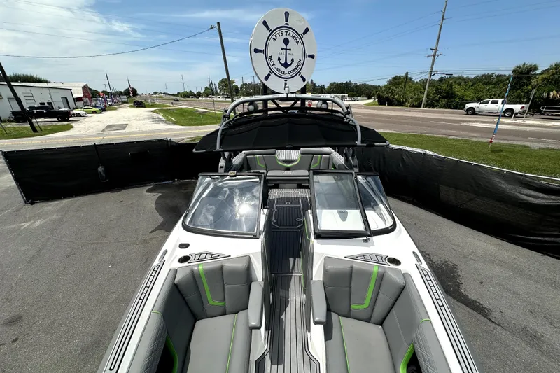 Slide: The Image of 2016 Nautique Super Air Nautique G25 Coastal Edition interior with gray and green seating. - 56