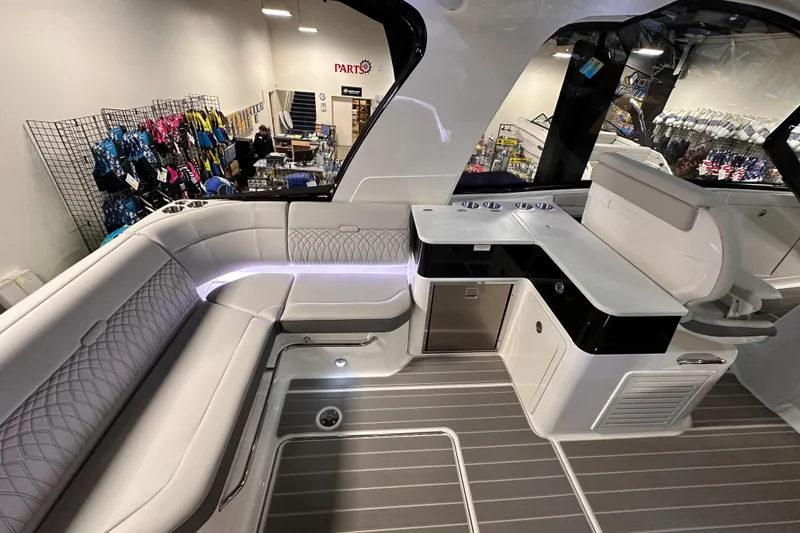 Slide: The Image of 2023 Sea Ray Sundancer 370 Outboard interior with seating and kitchenette in showroom. - 13