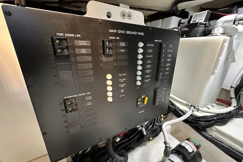 Slide: The Image of Electrical breaker panel on 2023 Sea Ray Sundancer 370 Outboard boat, featuring various switches and wiring. - 20