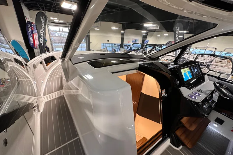 Slide: The Image of 2023 Sea Ray Sundancer 370 Outboard interior with modern helm and cabin entrance. - 29