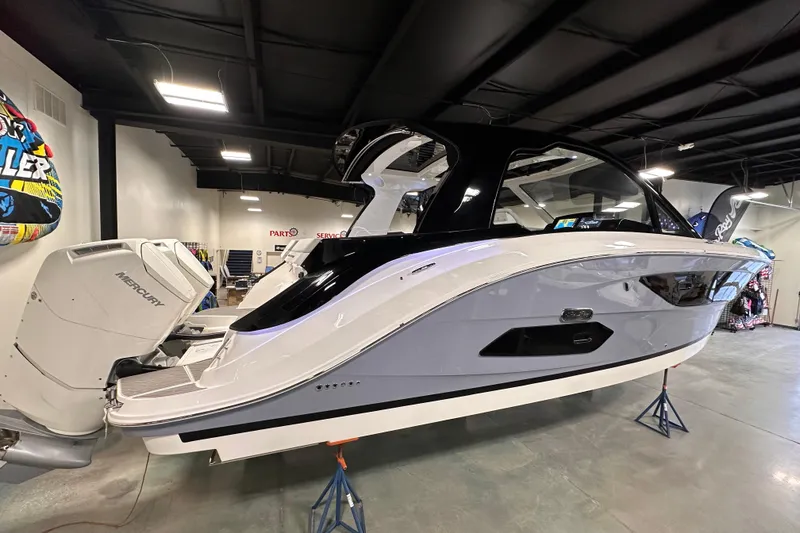 Slide: The Image of 2023 Sea Ray Sundancer 370 Outboard displayed indoors, showcasing sleek design and powerful engines. - 3