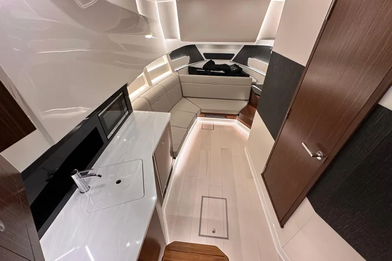 Slide: The Image of Luxurious interior of 2023 Sea Ray Sundancer 370 Outboard with modern kitchenette and seating area. - 36