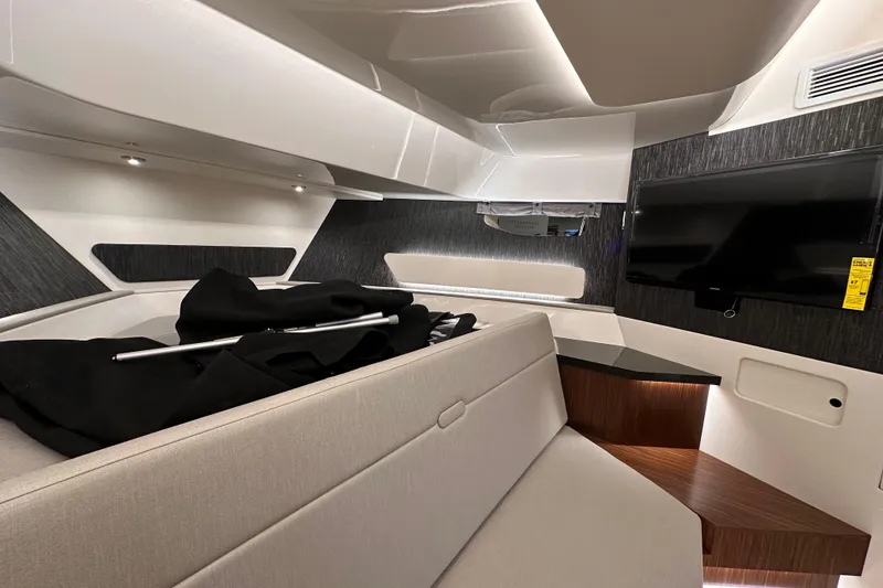 Slide: The Image of 2023 Sea Ray Sundancer 370 Outboard cabin interior with modern design and TV. - 40