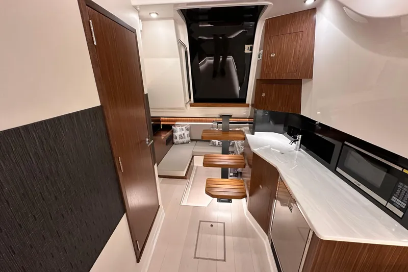 Slide: The Image of Luxurious interior of 2023 Sea Ray Sundancer 370 Outboard with modern kitchen and seating area. - 41