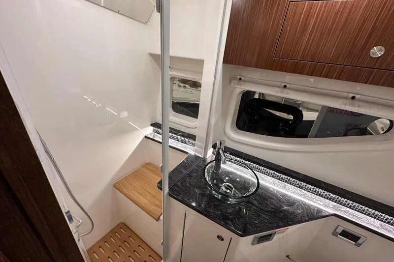 Slide: The Image of 2023 Sea Ray Sundancer 370 Outboard interior with modern sink and wooden accents. - 42