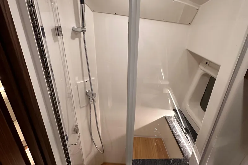 Slide: The Image of 2023 Sea Ray Sundancer 370 Outboard shower area with modern fixtures and sleek design. - 44