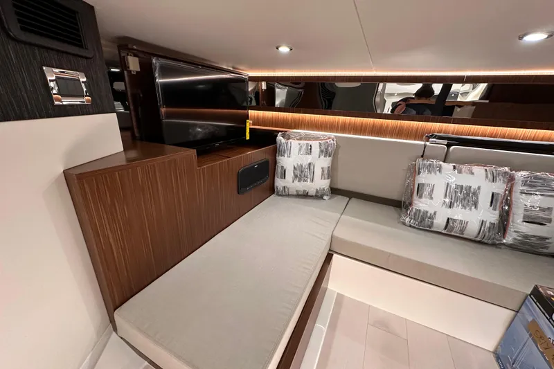 Slide: The Image of 2023 Sea Ray Sundancer 370 Outboard interior with modern seating and ambient lighting. - 45