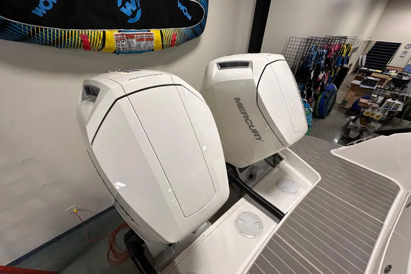 Slide: The Image of 2023 Sea Ray Sundancer 370 Outboard with dual Mercury engines in showroom. - 5