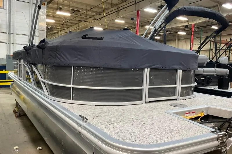 Slide: The Image of 2026 Bennington 22SXSR pontoon boat with cover in a warehouse setting. - 2