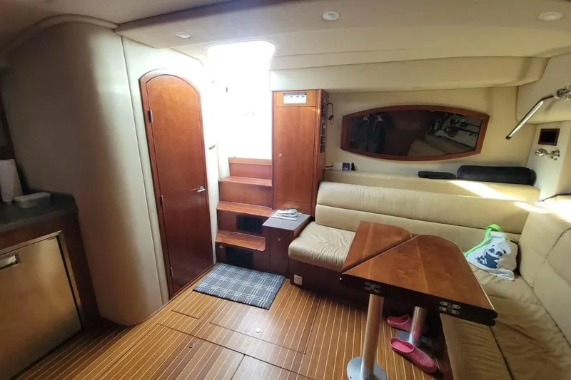 Slide: The Image of Interior of 2011 Rampage 41 Express yacht with wooden flooring and beige seating. - 12