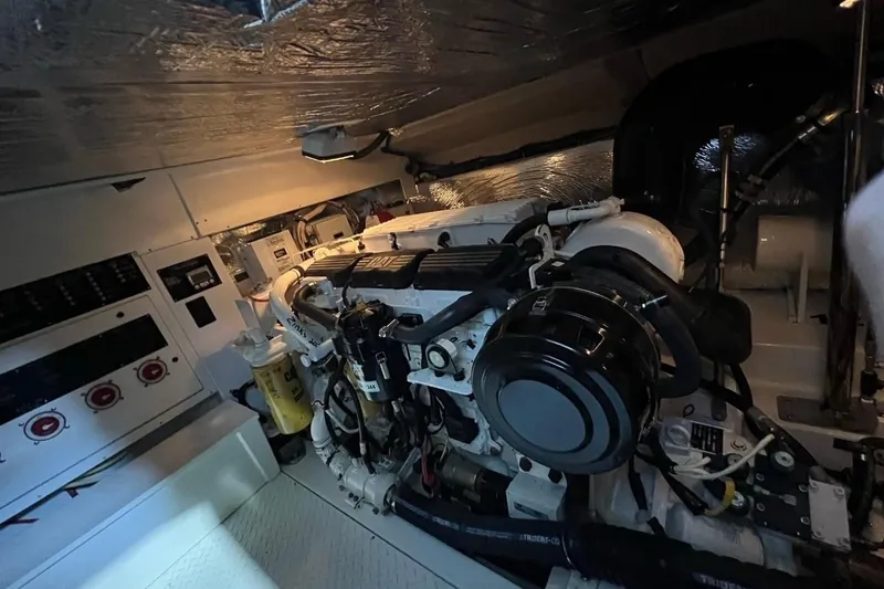 Slide: The Image of Engine room of 2011 Rampage 41 Express boat, featuring a well-maintained engine setup. - 16