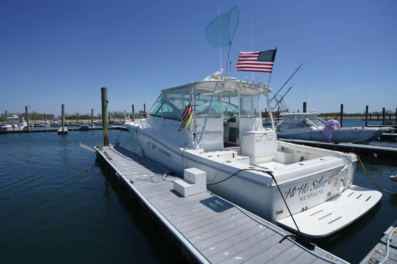 Slide: The Image of 2011 Rampage 41 Express boat docked at marina with American flag. - 3