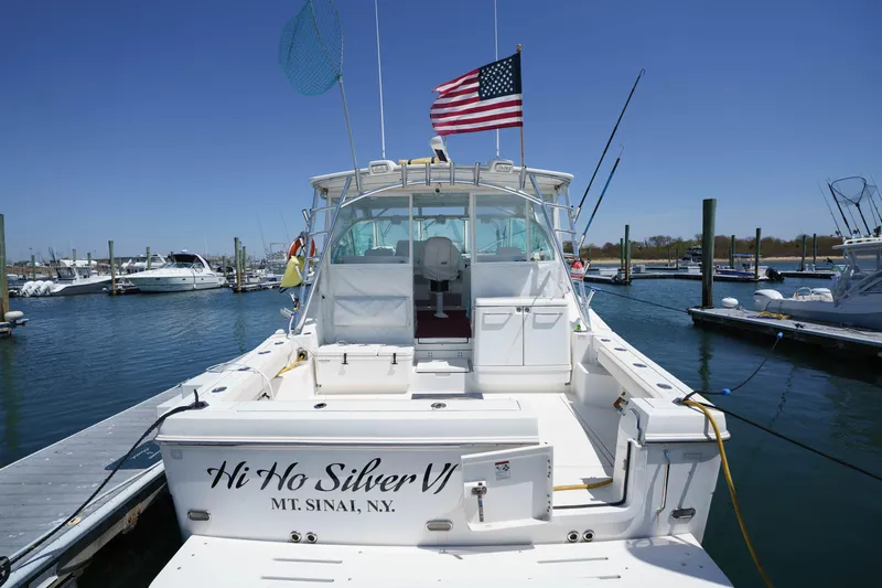 Slide: The Image of 2011 Rampage 41 Express boat docked, displaying American flag, named "Hi Ho Silver VI". - 4