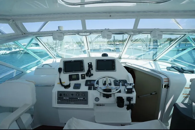 Slide: The Image of 2011 Rampage 41 Express yacht helm with navigation equipment and panoramic windows. - 6