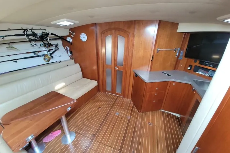 Slide: The Image of Luxurious interior of 2011 Rampage 41 Express yacht with wooden cabinetry and fishing rods. - 9