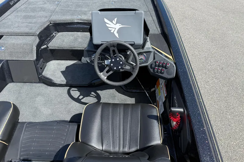 Slide: The Image of 2026 Skeeter ZXE21 boat cockpit with steering wheel and control panel. - 15