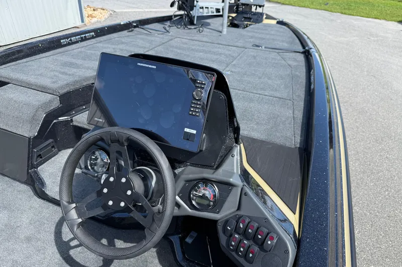 Slide: The Image of 2026 Skeeter ZXE21 boat dashboard with steering wheel and electronic display. - 17