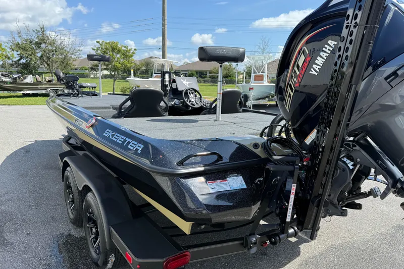 Slide: The Image of 2026 Skeeter ZXE21 boat with Yamaha engine, parked outdoors on a sunny day. - 21