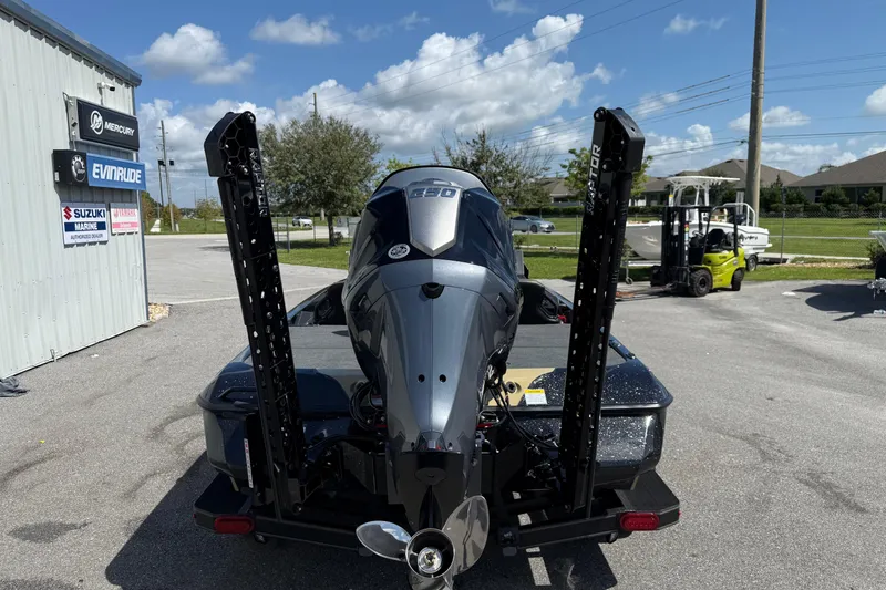 Slide: The Image of 2026 Skeeter ZXE21 boat with powerful outboard motor, parked near marine dealership. - 22