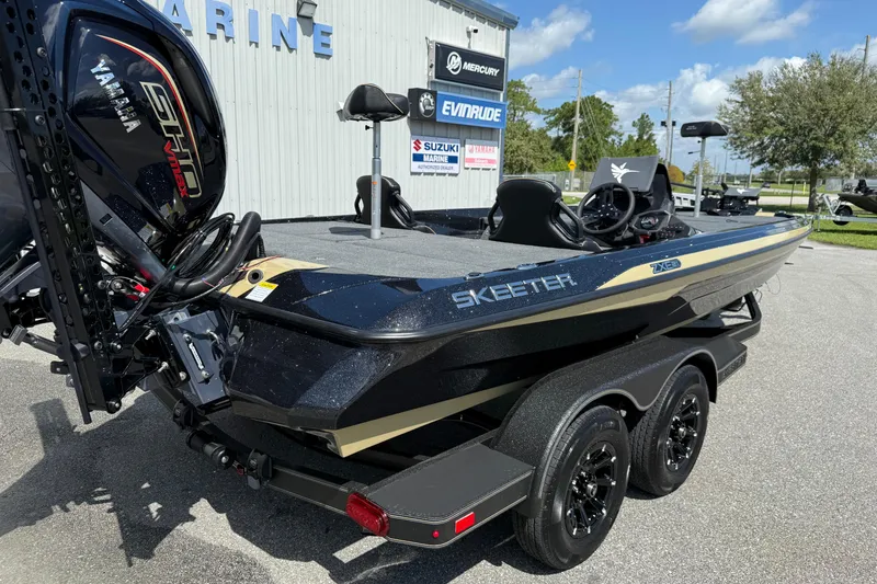 Slide: The Image of 2026 Skeeter ZXE21 boat with Yamaha engine, parked outdoors on a sunny day. - 23