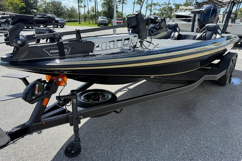 Slide: The Image of 2026 Skeeter ZXE21 boat on trailer with Minn Kota motor, parked outdoors. - 5