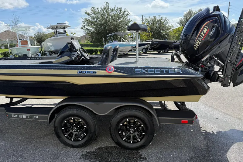 Slide: The Image of 2026 Skeeter ZXE21 boat on trailer with Yamaha engine, parked outdoors. - 6
