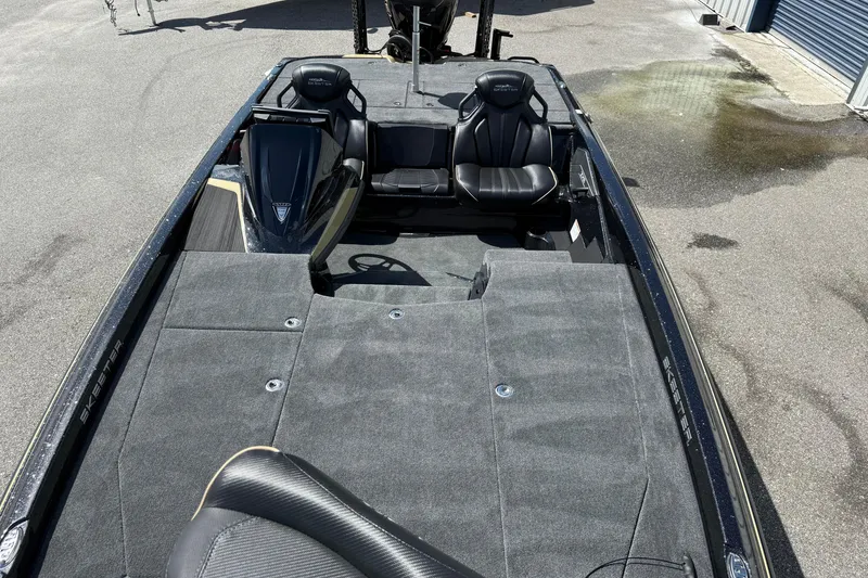 Slide: The Image of 2026 Skeeter ZXE21 boat interior with seating and carpeted deck. - 9