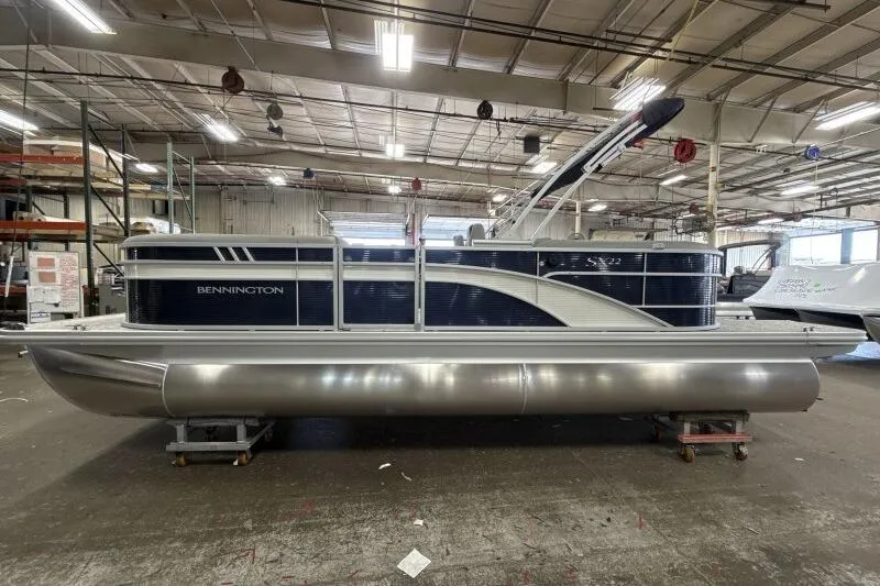The Image of 2026 Bennington 22SXSR pontoon boat in a warehouse setting. - 1