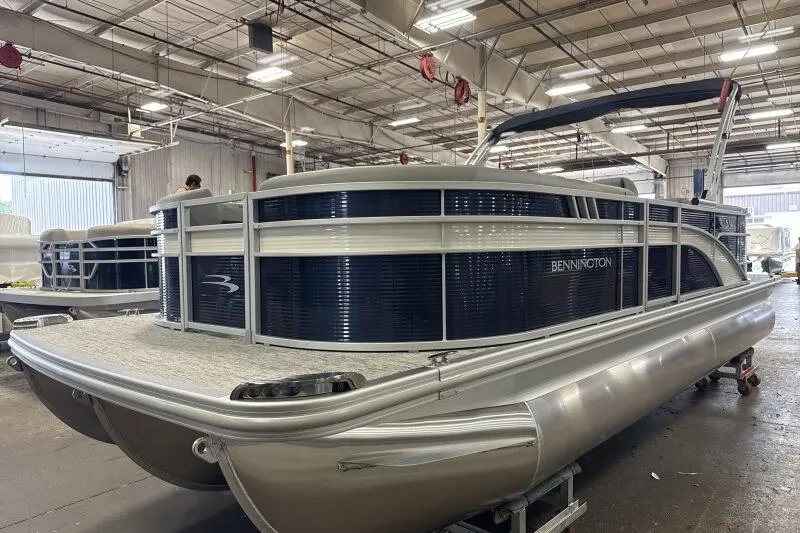 Slide: The Image of 2026 Bennington 22SXSR pontoon boat in a spacious indoor facility. - 2