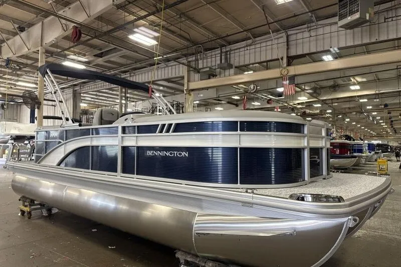 Slide: The Image of 2026 Bennington 22SXSR pontoon boat in a factory setting, showcasing sleek design. - 3