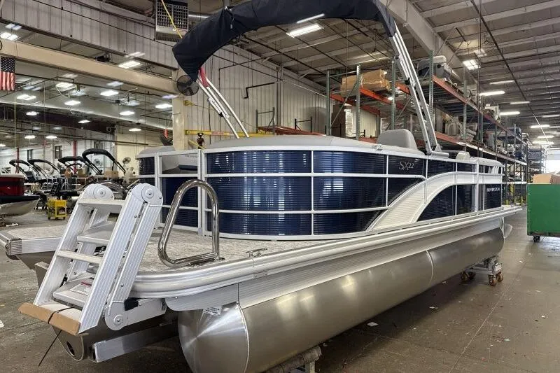 Slide: The Image of 2026 Bennington 22SXSR pontoon boat in a factory setting, showcasing sleek design and modern features. - 4