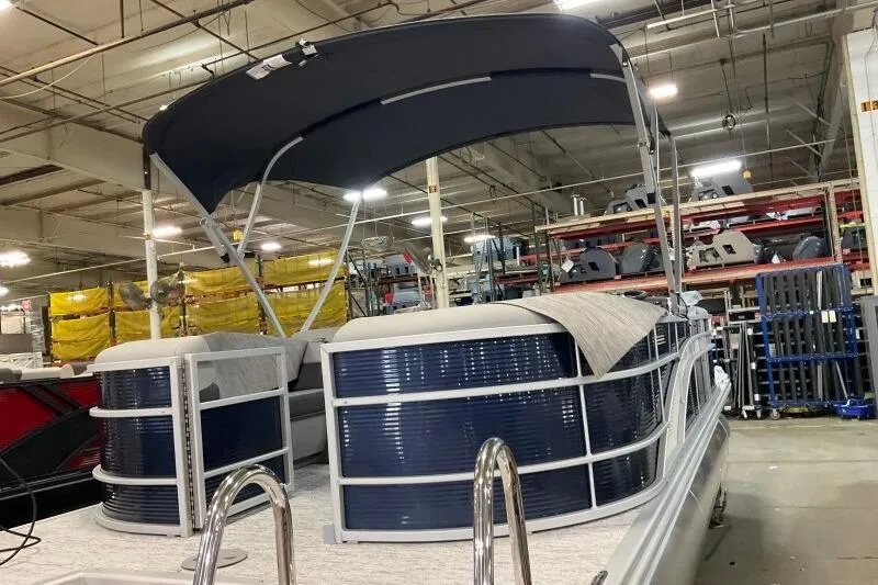 Slide: The Image of 2026 Bennington 22SXSR pontoon boat in a warehouse setting. - 5