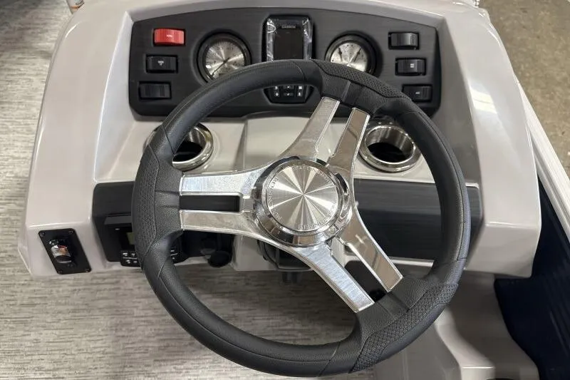 Slide: The Image of Steering wheel and dashboard of 2026 Bennington 22SXSR boat, featuring modern controls. - 9