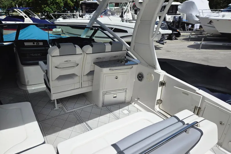 Slide: The Image of 2022 Chaparral 280 OSX boat interior with seating and kitchenette area. - 16