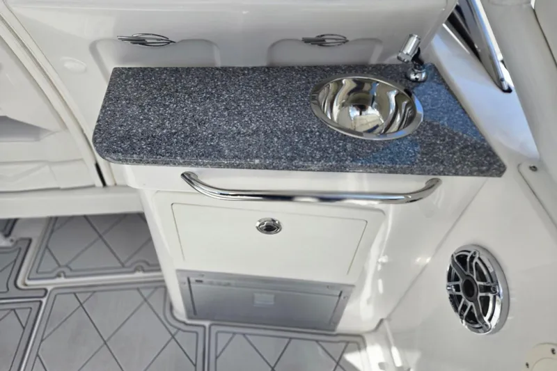 Slide: The Image of 2022 Chaparral 280 OSX boat interior with sink and countertop. - 18