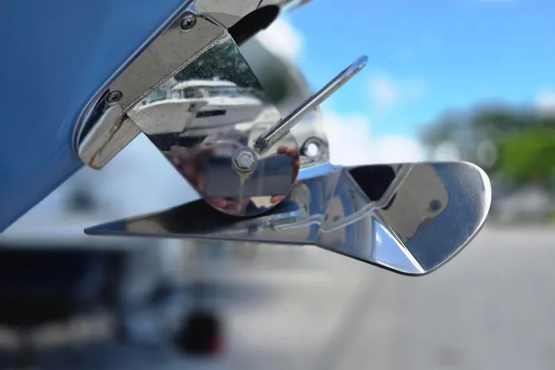 Slide: The Image of Close-up of a 2022 Chaparral 280 OSX boat's polished metal trim tab. - 20