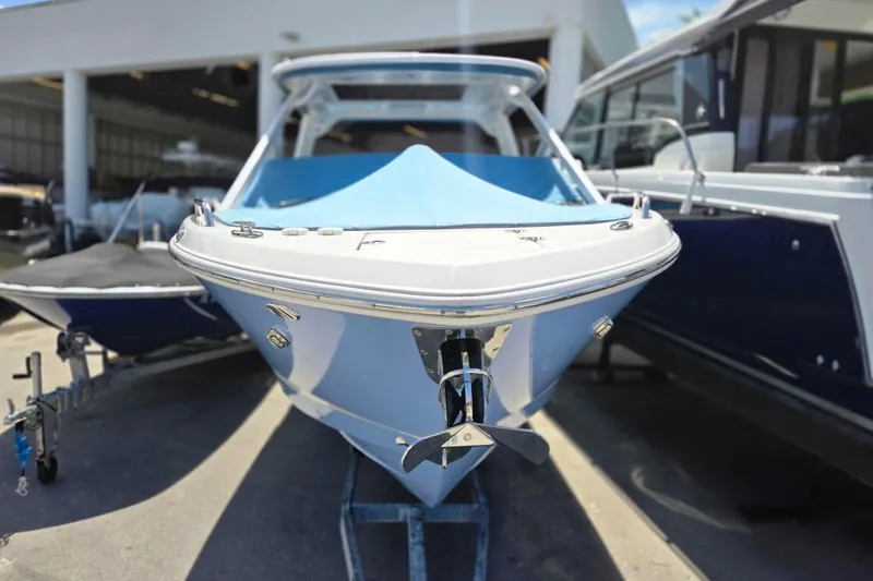 Slide: The Image of 2022 Chaparral 280 OSX boat displayed in a showroom, front view. - 22