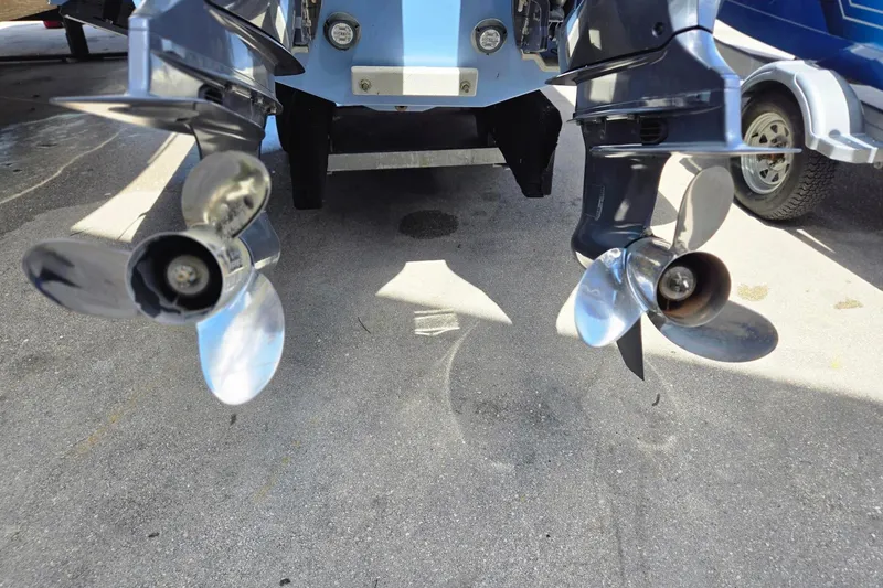 Slide: The Image of 2022 Chaparral 280 OSX boat propellers on a trailer, showcasing dual outboard motors. - 23