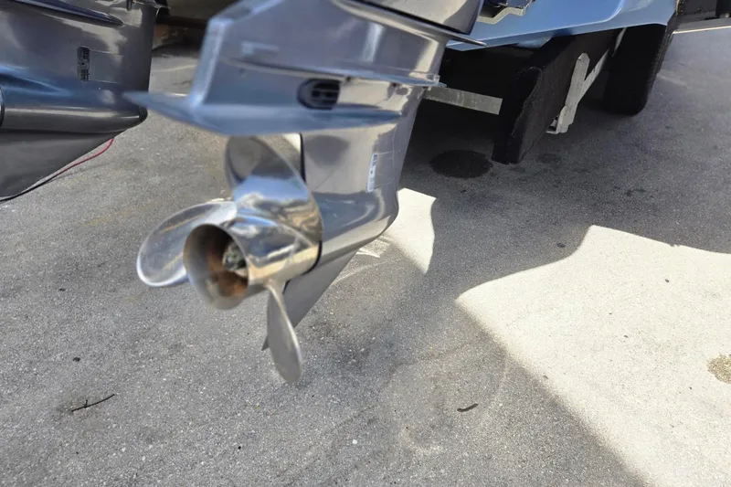 Slide: The Image of Close-up of a 2022 Chaparral 280 OSX boat propeller on concrete surface. - 24