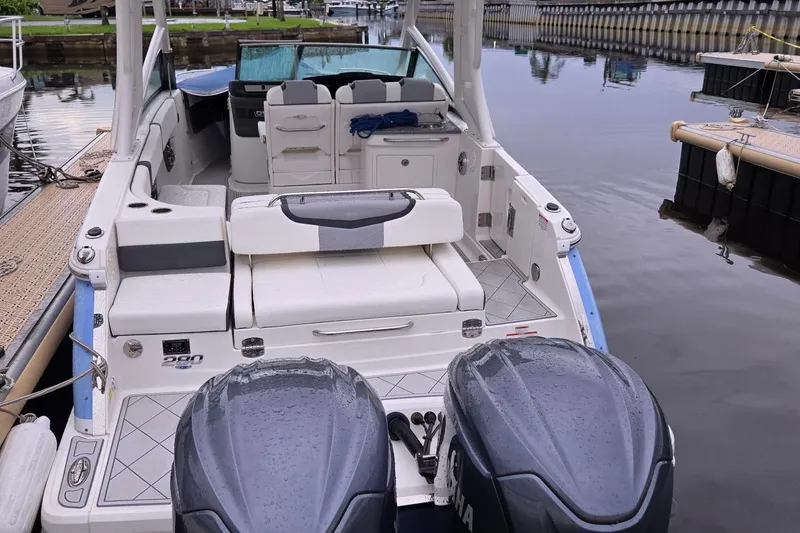 Slide: The Image of 2022 Chaparral 280 OSX boat with dual engines docked at a marina. - 29