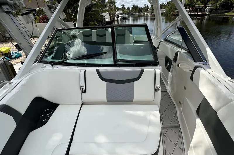 Slide: The Image of 2022 Chaparral 280 OSX boat interior with white seating and sleek design. - 8