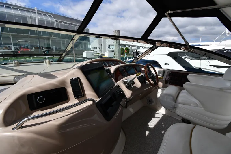 Slide: The Image of Interior view of 2000 Sea Ray 460 Sundancer yacht cockpit with steering wheel and controls. - 10