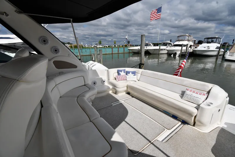 Slide: The Image of Luxurious 2000 Sea Ray 460 Sundancer yacht interior with comfortable seating and American flag. - 18