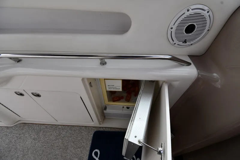 Slide: The Image of Interior view of a 2000 Sea Ray 460 Sundancer yacht with open storage compartment. - 21