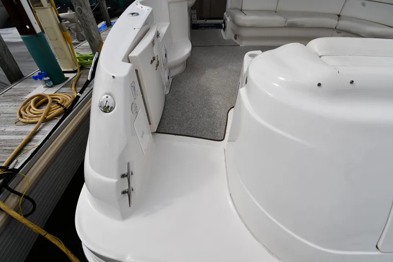 Slide: The Image of 2000 Sea Ray 460 Sundancer yacht deck with seating and dockside view. - 23