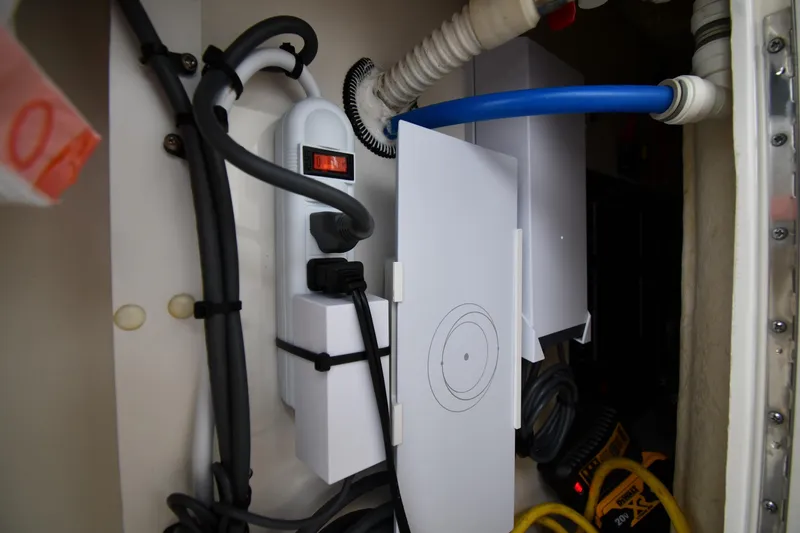 Slide: The Image of Electrical setup inside a 2000 Sea Ray 460 Sundancer boat, featuring cables and switches. - 26